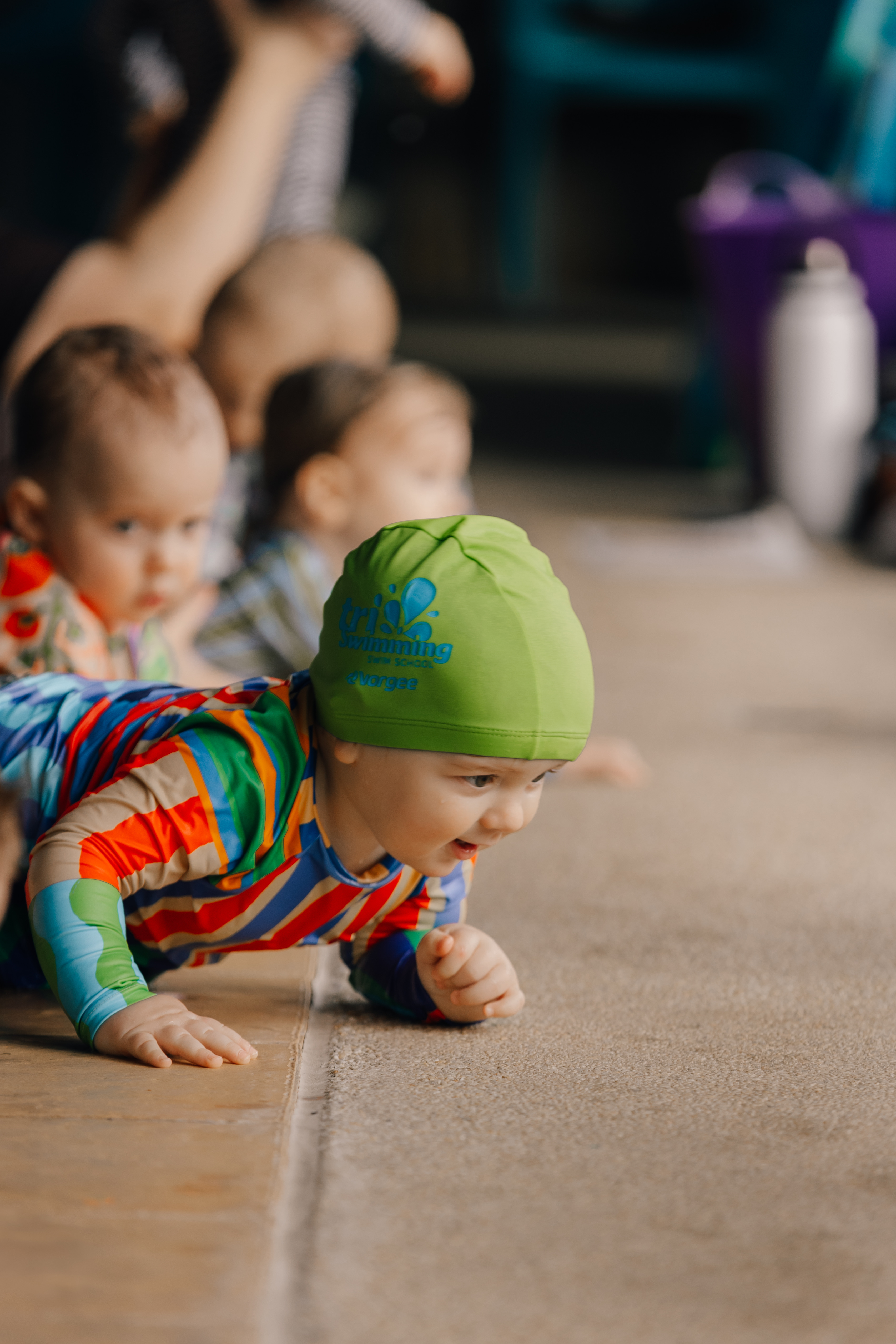 Baby crawling poolside at Tri Swimming