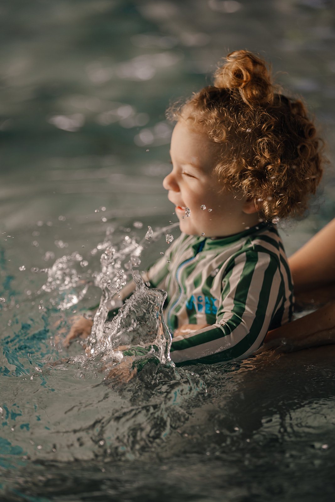 Toddler playing in the pool at Tri Swimming